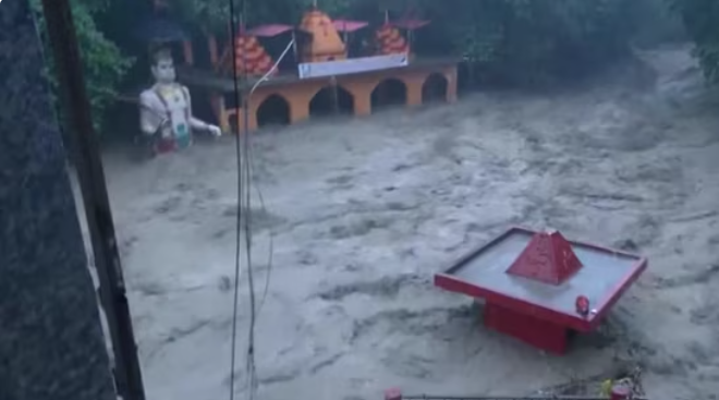 Floodwaters from the swollen Tamsa river submerge the Tapkeshwar Mahadev temple premises in Dehradun after heavy rainfall and a suspected cloudburst. (PC: Screengrab/X/@ANI)