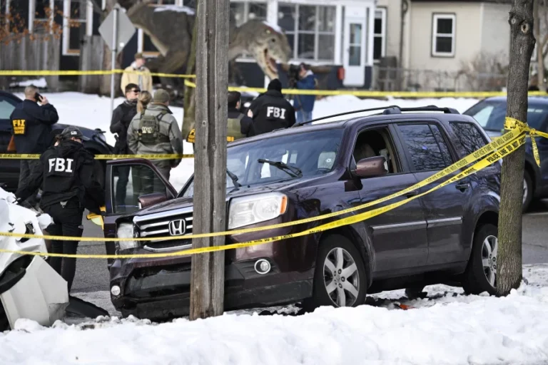 Federal law-enforcement officers secure the scene after a fatal shooting during an immigration enforcement operation in south Minneapolis, where a vehicle struck a parked car following the incident. Authorities say investigations are ongoing. (Photo Credits: AP)