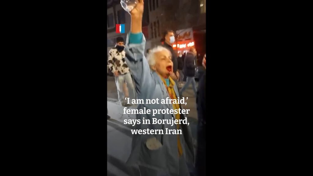An elderly woman raises her arm and chants anti-government slogans during a nighttime protest in Borujerd, western Iran, in a viral video that has become a symbol of growing public defiance against the Islamic Republic. (Photo Credits: X@/AmirhosseinMiresmaeili)